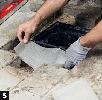 Fibertexen | Sivebrønd med sten i flisebelægning Fibertexen | Sivebrønd med sten i flisebelægning